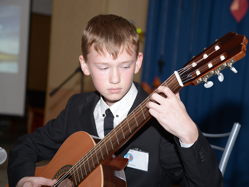 Андрей Конников, член православной молодежной организации «Ковчег», исполняет музыкальную композицию на гитаре